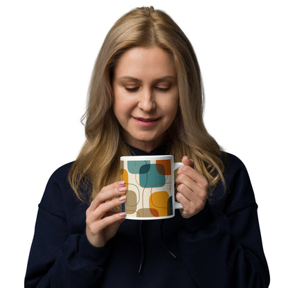 Retro geometric ceramic coffee mug featuring mid-century rounded squares and lines in teal, mustard yellow, and orange.