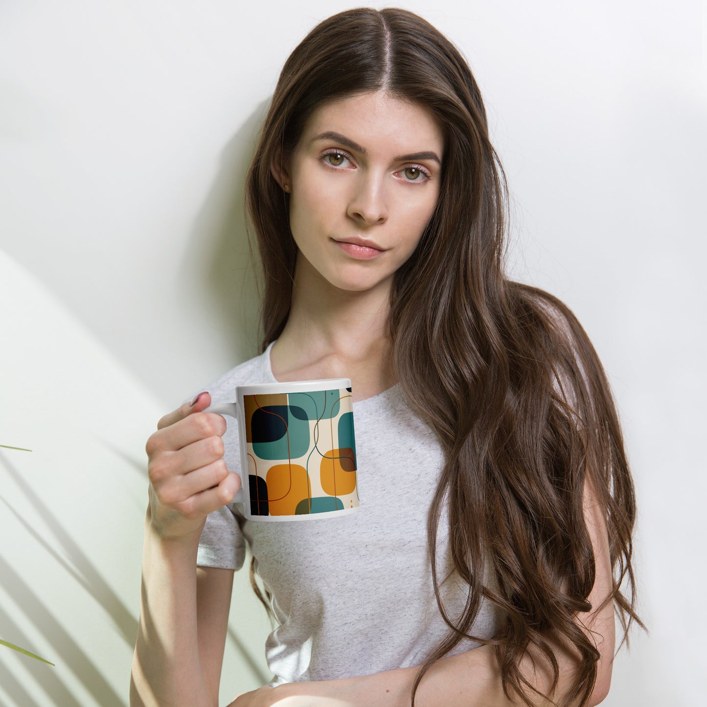 Retro geometric ceramic coffee mug featuring mid-century rounded squares and lines in teal, mustard yellow, and orange.
