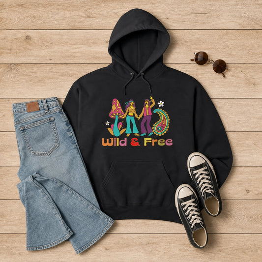 Front view of a cream unisex hoodie featuring a retro 1960s-style "Wild and Free" graphic with colorful vintage flowers.